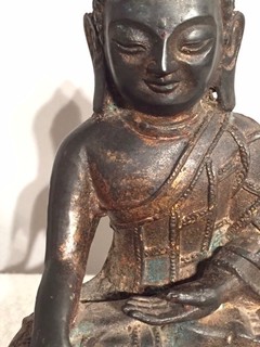 A 17th Century Cast Bronz Sculpture of a Buddha with traces of Lacquer and gilding. Thebethian.