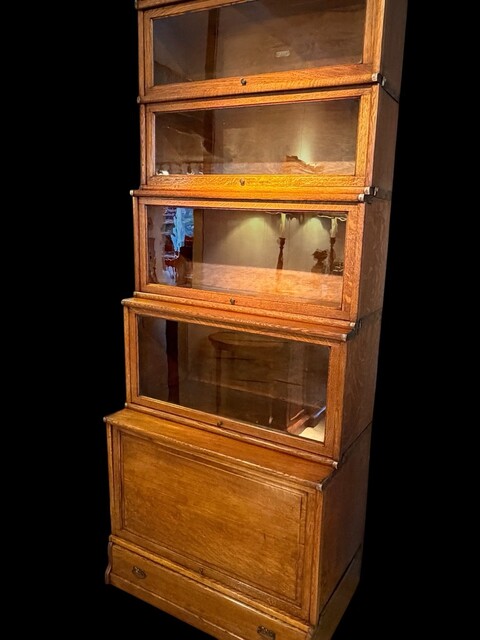 A 19th Century English Waterfall Globe Wernicke Oak Bookcase with Cupboard Base