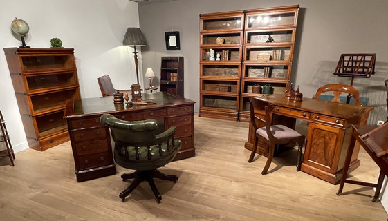 A 19th Century Partner's Desk. A 19th Century Walnut Desk. A Pair of Oak Globe Wernicke Bookcases. An Early 19th Century English Mahogany Bookcase.An Early 20th Century Captains Desk Chair.