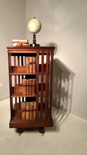 A 19th Century Three Tier English Mahogany Revolving Bookcase having a Cast-Iron Base. Signed Maple & Co.