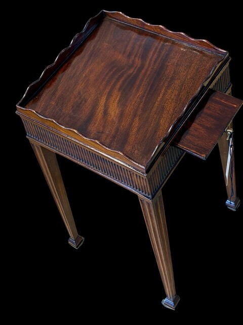 A fine George III mahogany kettle stand, circa 1810, with a shaped gallery, reeded frieze, pull out slide and brass castors.