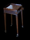 A fine George III mahogany kettle stand, circa 1810, with a shaped gallery, reeded frieze, pull out slide and brass castors.