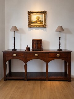 A George III Welsh oak potboard dresser, circa 1770, from Mid Wales, with a triple arched apron, distinctive silhouette legs and a beautiful original patina.