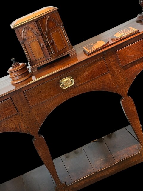 A George III Welsh oak potboard dresser, circa 1770, from Mid Wales, with a triple arched apron, distinctive silhouette legs and a beautiful original patina.