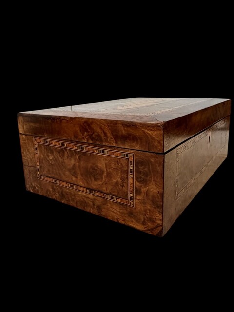 A Victorian English Trinity House Box in burr walnut with maritime marquetry, geometric parquetry borders and a fitted interior, dating from the mid 19th century.