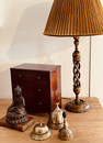 An Antique Kashmiri Lamp Stand. A 17th Century Thebethian Cast Bronze Buddha.. A 19th Century Mahogany Miniature Chest of Drawers. 19th Century Victorian Bells.