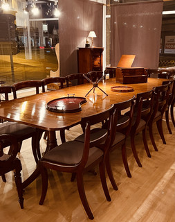 An Early 20th Century Mahogany Extending Dining Table and a Set of Eight William IV Mahogany Dining Chairs.