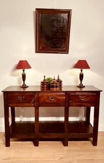 An English 18th Century Oak Low Dresser with Potboard having three Drawers.