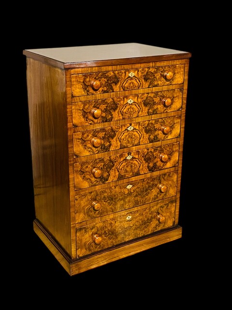 An English 19th Century Burr Walnut Cabinet of Drawers. Signed Heals of London.