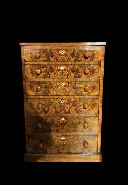 An English 19th Century Burr Walnut Cabinet of Drawers. Signed Heals of London.