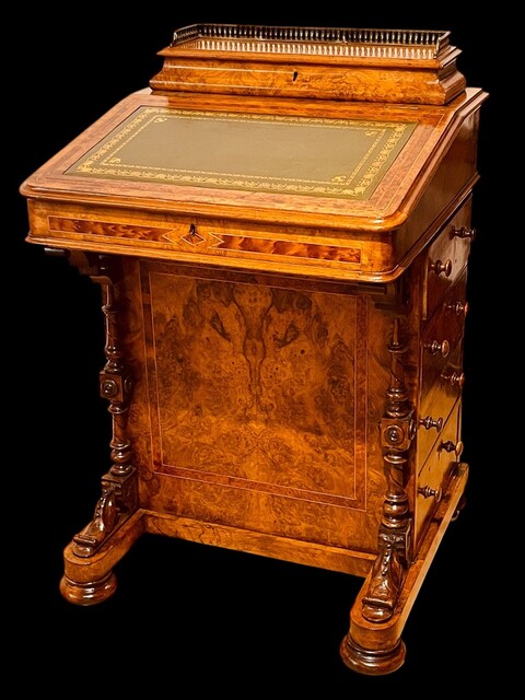 An English 19th Century Burr Walnut Davenport Desk decorated with cross banding throughout and having a satinwood interior.