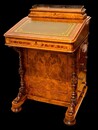 An English 19th Century Burr Walnut Davenport Desk decorated with cross banding throughout and having a satinwood interior.
