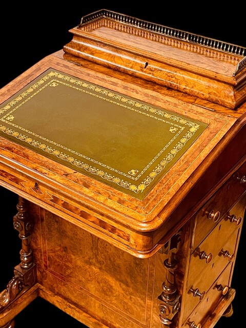 An English 19th Century Burr Walnut Davenport Desk decorated with cross banding throughout and having a satinwood interior.
