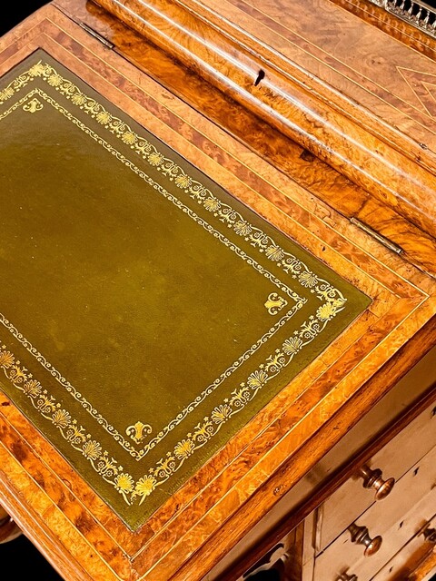 An English 19th Century Burr Walnut Davenport Desk decorated with cross banding throughout and having a satinwood interior.