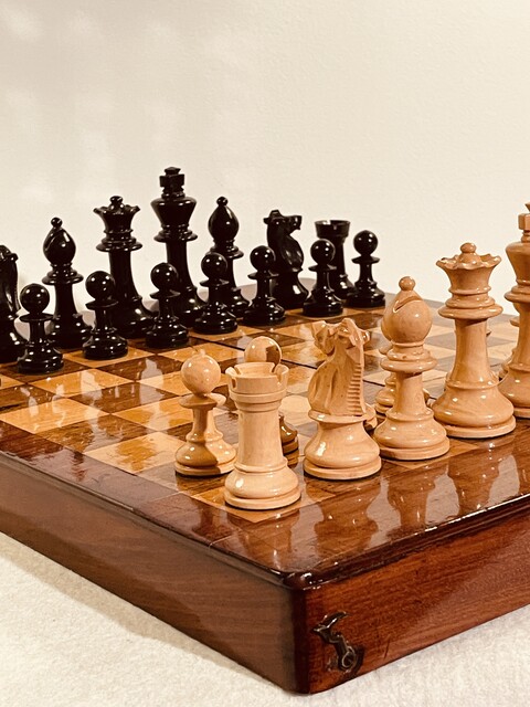 An English 19th Century Mahogany Chess Board / Box and an English 19th Century Staunton Chess Set.
