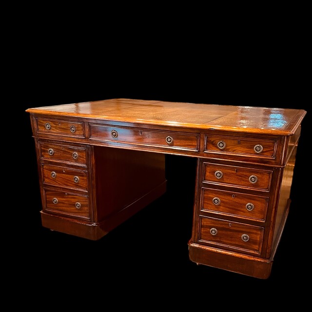 An English 19th Century Mahogany Partners Desk having a beautiful Old Leather.