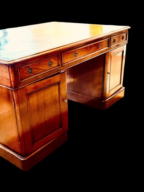 An English 19th Century Mahogany Partners Desk having a beautiful Old Leather.