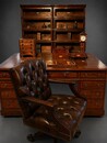An English 19th Century mahogany partner's desk with a pair of Globe-Wernicke bookcases and a revolving leather desk chair. Fine quality antique office furniture.
