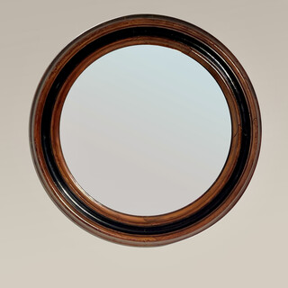 An English 19th Century Walnut and Ebony Framed Round Mirror.