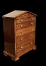 An English Antique Apprentice Piece Chest of Drawers having a pediment top above five graduated drawers.