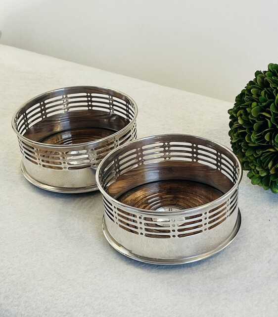 An English Art Deco Pair Silver Plated Wine Coasters having a Wood Turned Base.