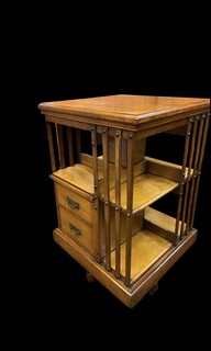 An English Arts and Crafts Oak Revolving Bookcase having two drawers. Metal Base.