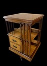 An English Arts and Crafts Oak Revolving Bookcase having two drawers. Metal Base.