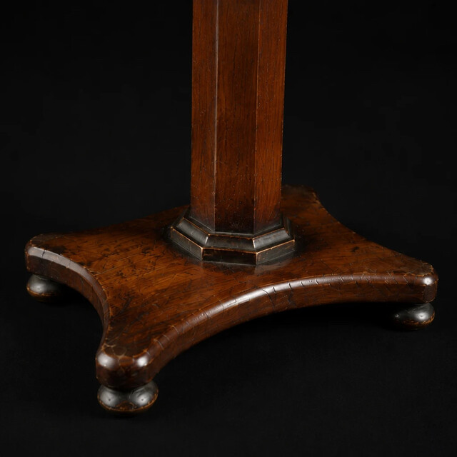 An English early 19th century apprentice mahogany tilt top table with an octagonal pedestal, platform base and rich original patina. A finely made miniature cabinetmaker's apprentice piece.