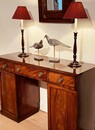 An English Early 19th Century Mahogany Sideboard having Three Drawers and Two Cupboards.