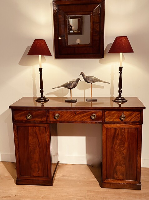 An English Early 19th Century Mahogany Sideboard having Three Drawers and Two Cupboards.