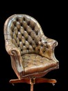 An English Early 20th Century Revolving Chesterfield Desk Chair having a reclining mechanism and is adjustable in hight.