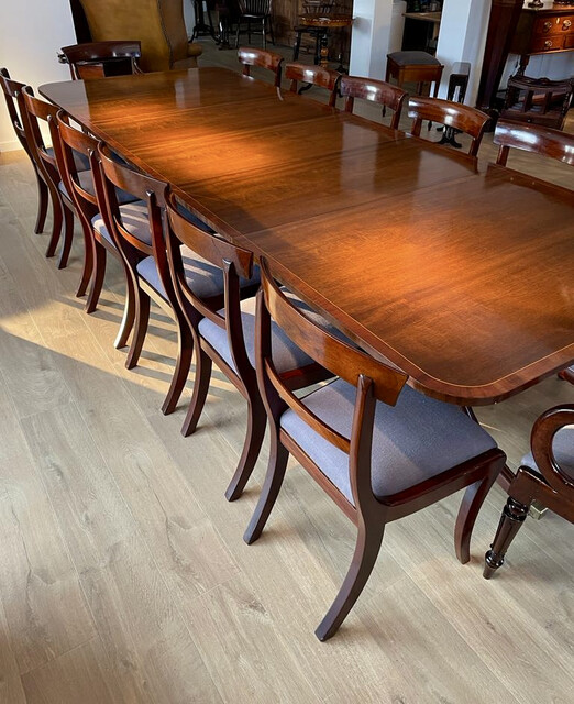 An English Edwardian Mahogany Extending Dining Table and A Set of Eight William IV Mahogany Chairs.