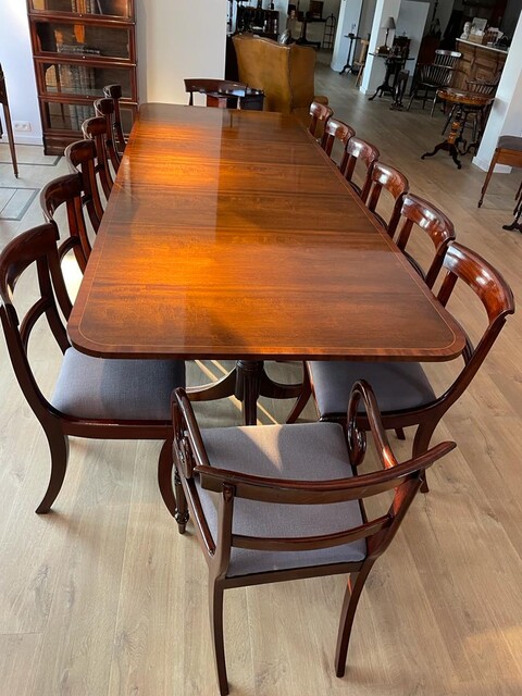 An English Edwardian Mahogany Extending Dining Table and A Set of Eight William IV Mahogany Chairs.