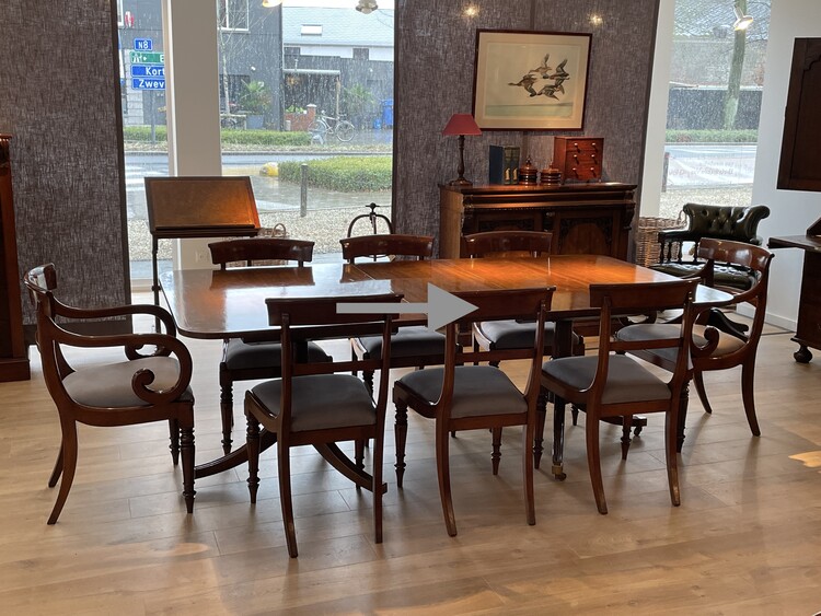 An English Edwardian Mahogany Extending Dining Table and A Set of Eight William IV Mahogany Chairs.