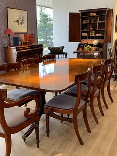 An English Edwardian Mahogany Extending Dining Table and A Set of Eight William IV Mahogany Chairs.