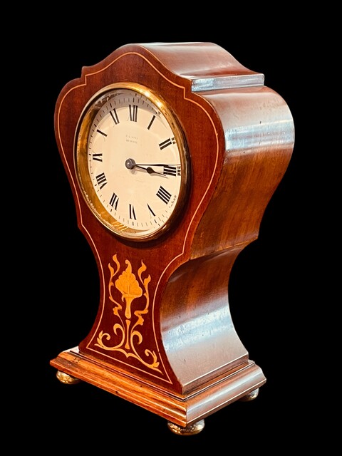 An English Edwardian Mahogany Mantel Clock with Floral Satinwood Inlay.