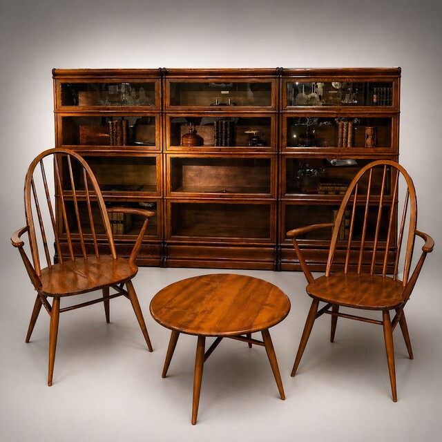 An English Ensemble of a pair of 1950s Ercol Chairs and Coffee Table in front of Three 19th Century Globe Wernicke Bookcases.