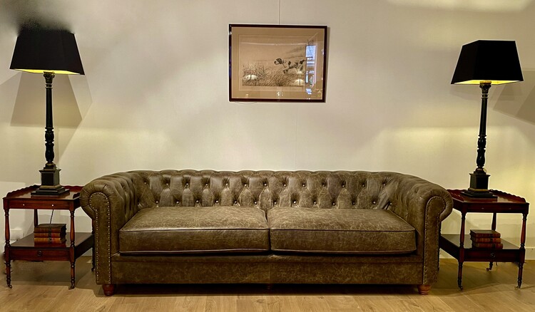 An English Green leather Chesterfield Sofa. A Pair of Antique Burr Walnut Side Tables and a Beautiful English 19th Century Pair of Lamp Stands. Classical Column Ebenised an Gilded.