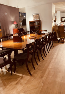 An English Mahogany Extending Dining Table. A Set of Twelve + Two Regency Dining Chairs. A Mahogany Globe Wernicke Bookcase.