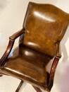 An English Mid 20th Century Green Leather Gainsborough Chesterfield Swivel Desk Chair adjustable in Height