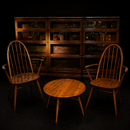 An English Mid-Century Ercol Set with Pair of Armchairs, Coffee Table and Globe Wernicke Bookcases
