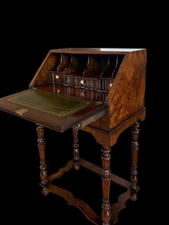 Elegant antique English burr walnut bureau on stand with a fitted interior, leather writing surface and beautiful original patina. 